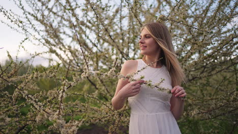 pretty-young-woman-is-posing-near-blooming-cherry-tree-in-garden-in-spring-day-portrait
